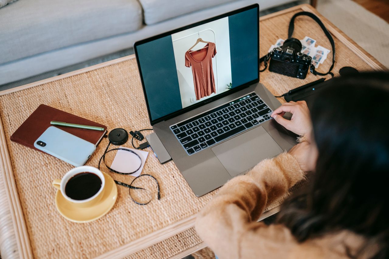 Crafting Captivating Headlines: Your awesome post title goes here From above back view of crop anonymous female remote employee showing photography on netbook screen at table with hot drink